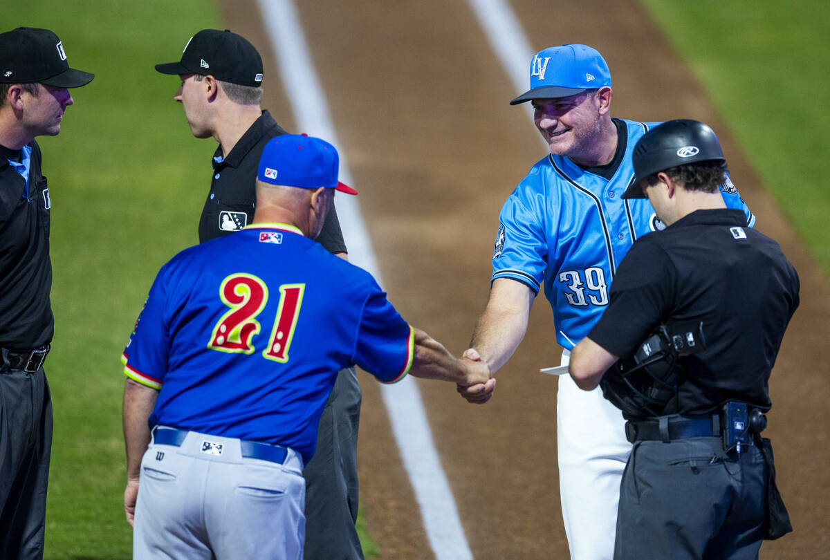 Aviators manager Fran Riordan and El Paso Chihuahuas bench coach Pete Zamora greet along with u ...