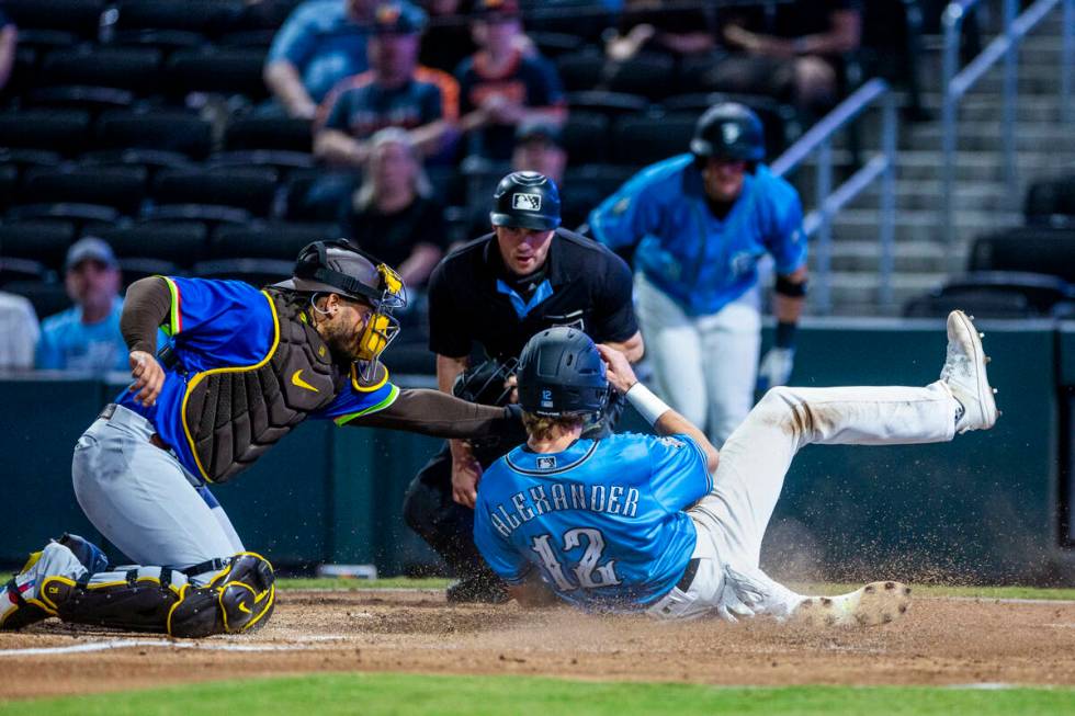 Aviators infielder CJ Alexander (12) slides home safely as the tag is late from El Paso Chihuah ...