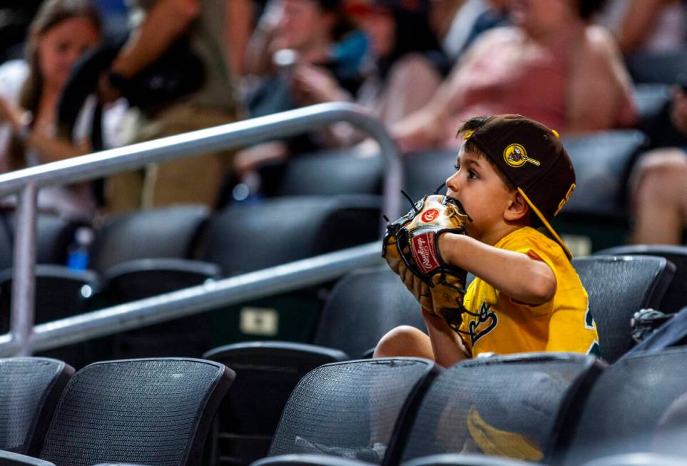 A young fan chews on his glove as the Aviators battle the El Paso Chihuahuas during their base ...