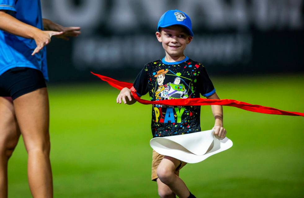 A young boy crosses the finish line in a race as the Aviators battle the El Paso Chihuahuas dur ...