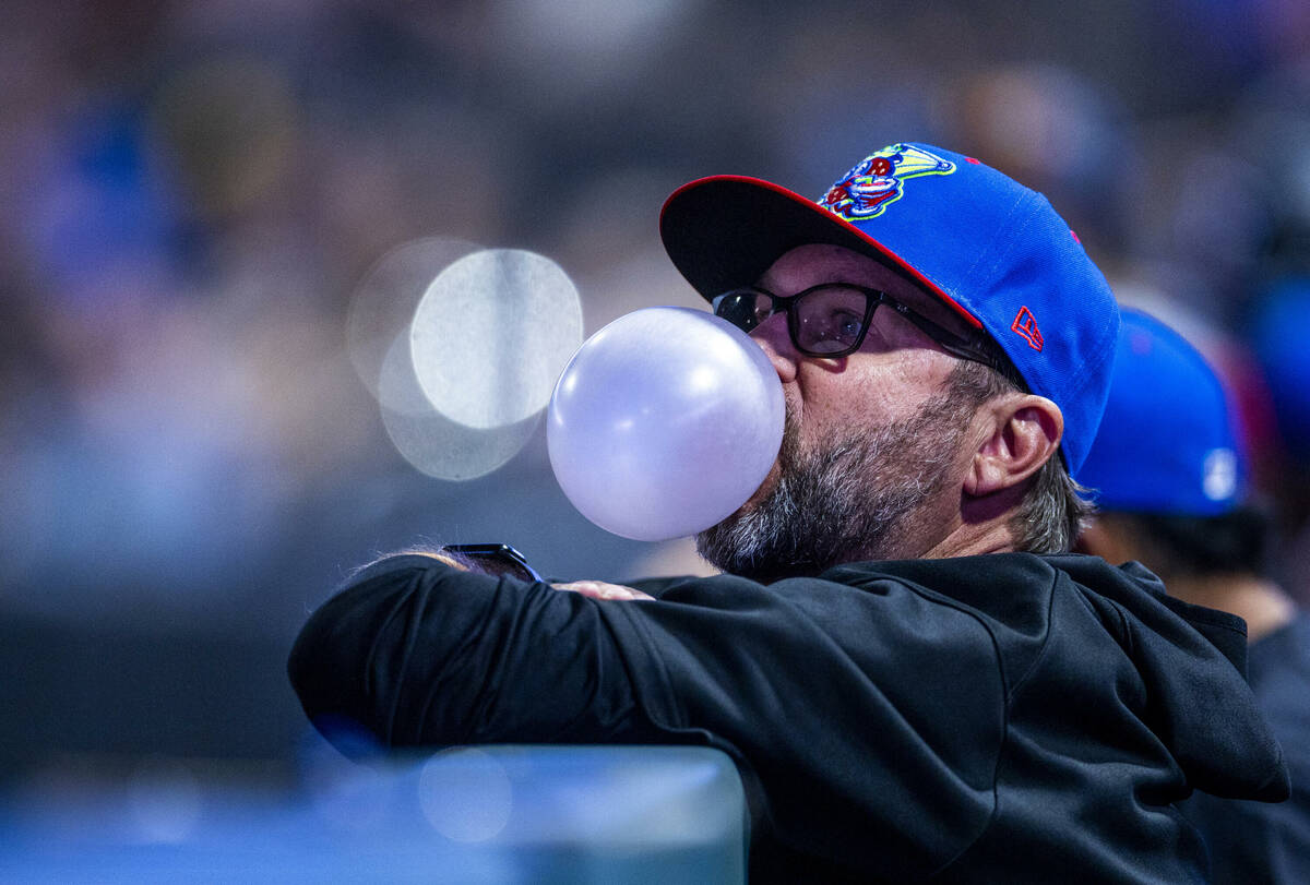 An El Paso Chihuahuas coach blows bubbles in the dugout as they face the Aviators during their ...