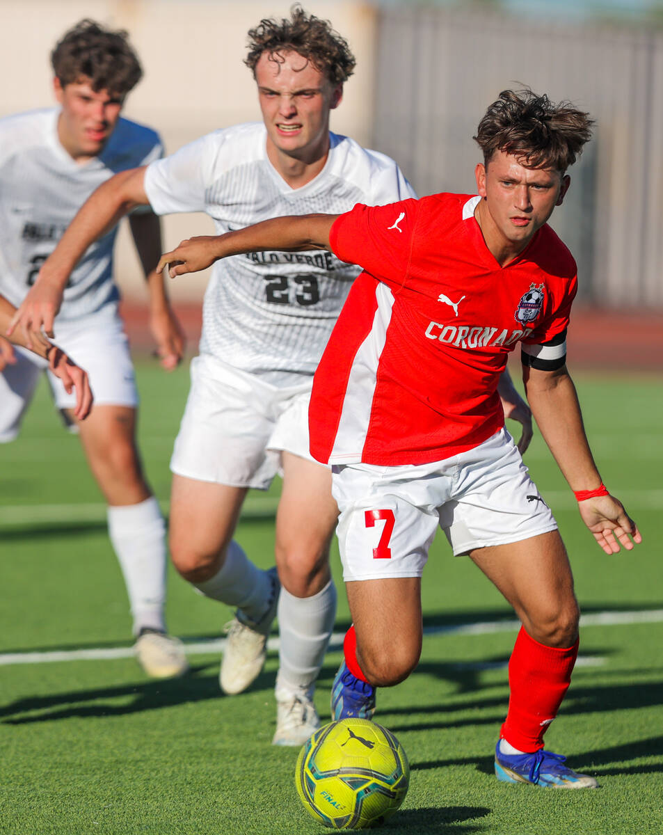 Coronado midfielder Austin Kiernan (7) and Palo Verde defender Benjamin Legrand (23) race after ...