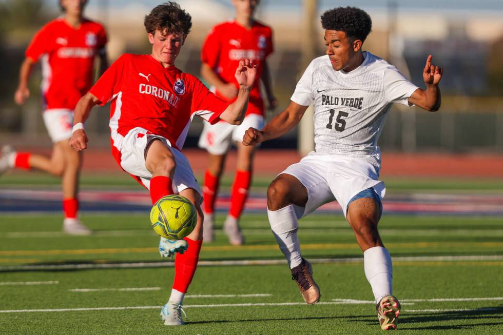 Coronado midfielder Gavin Biddinger (14) kicks the ball up as Palo Verde forward Trevon Aytch f ...