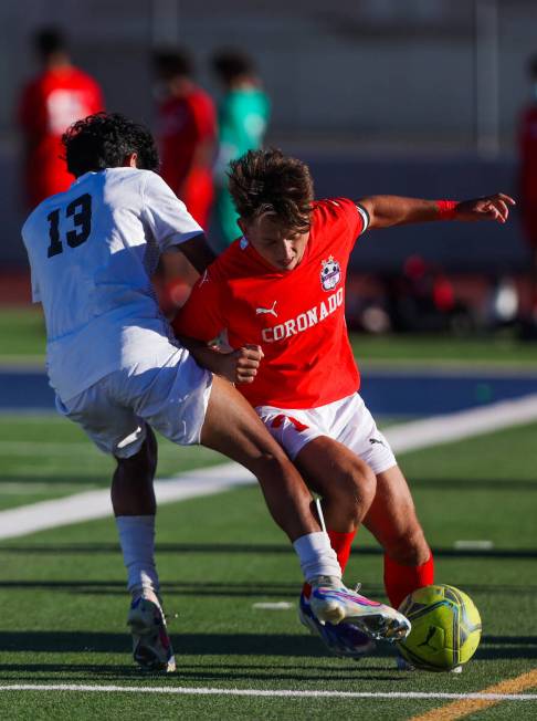 Coronado midfielder Austin Kiernan (7) and Palo Verde fullback Haydn Rodrigues (13) fight for p ...