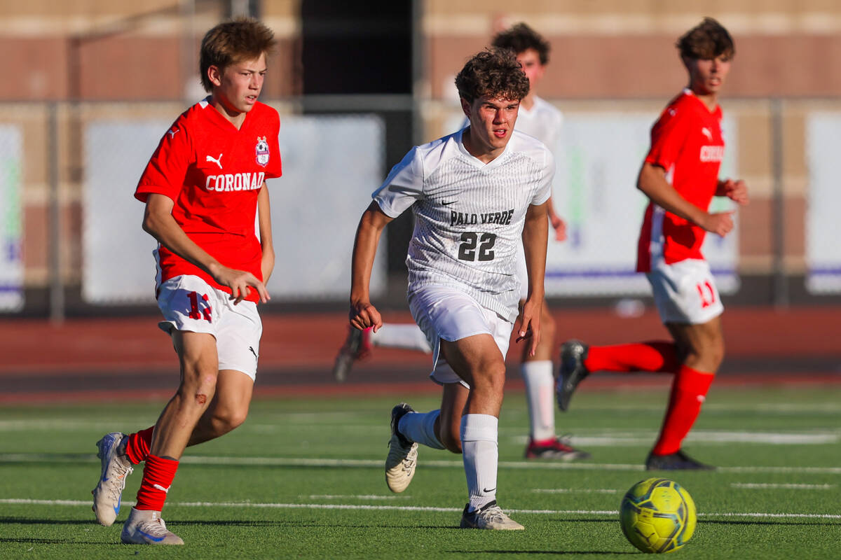 Palo Verde midfielder Trustin Parker (22) and Coronado midfielder Liam Bringhurst (12) chase th ...