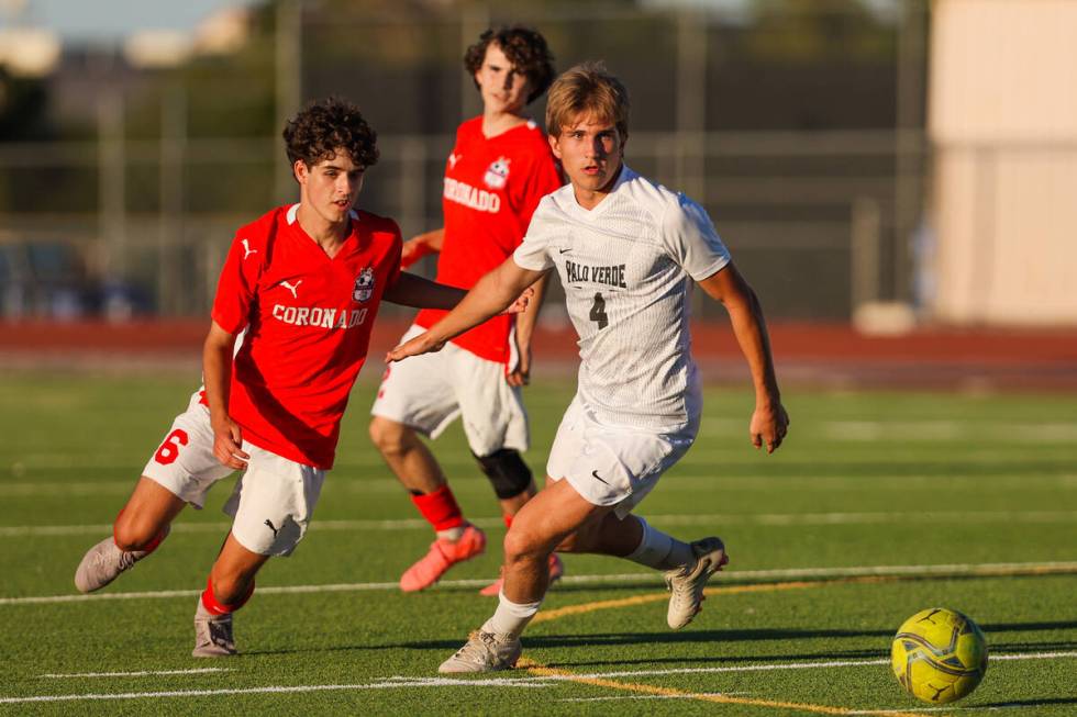 Palo Verde forward Adam Knecht (4) and Coronado midfielder Dalton Meusy (6) chase the ball duri ...