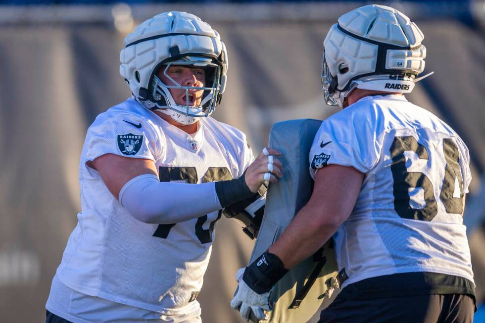 Raiders guard Jackson Powers-Johnson (70) and guard Clark Barrington (64) on a drill during pra ...