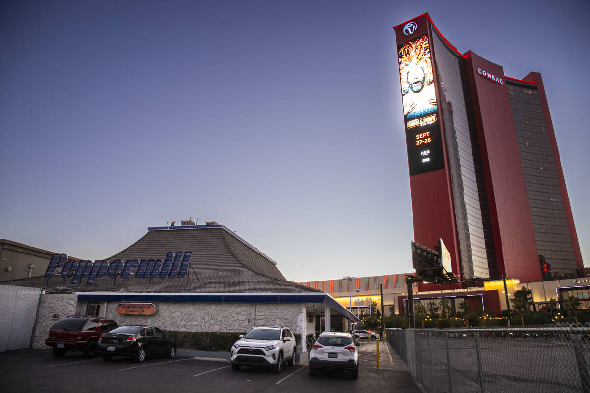 An exterior view from the back showing the old signage at the Peppermill Restaurant and Firesid ...