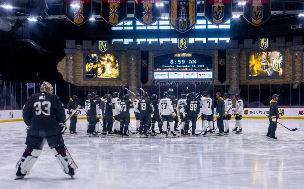 Golden Knights Head Coach Bruce Cassidy gathers his players on the ice during the first day of ...