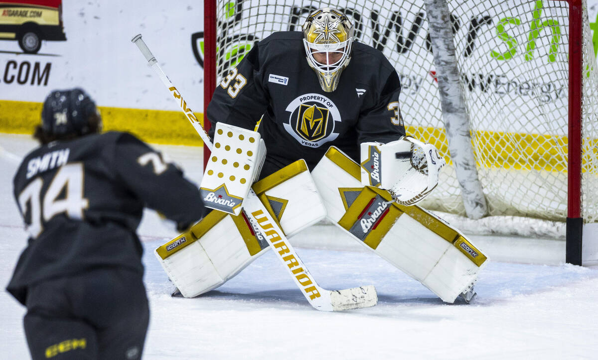 Vegas Golden Knights goaltender Adin Hill (33) stops a shot by forward Shane Smith (74) during ...