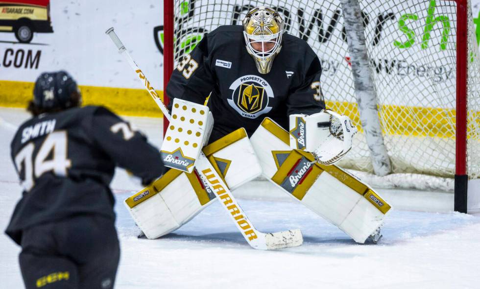 Vegas Golden Knights goaltender Adin Hill (33) stops a shot by forward Shane Smith (74) during ...