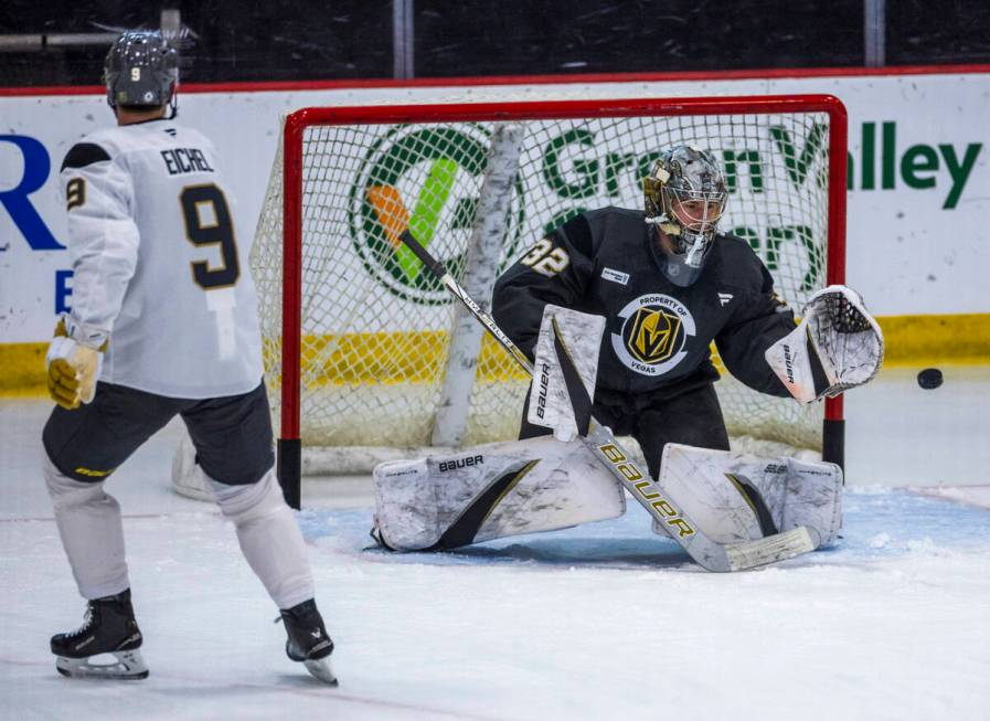 Golden Knights center Jack Eichel (9) watches a shot on goaltender Jesper Vikman (32) during th ...