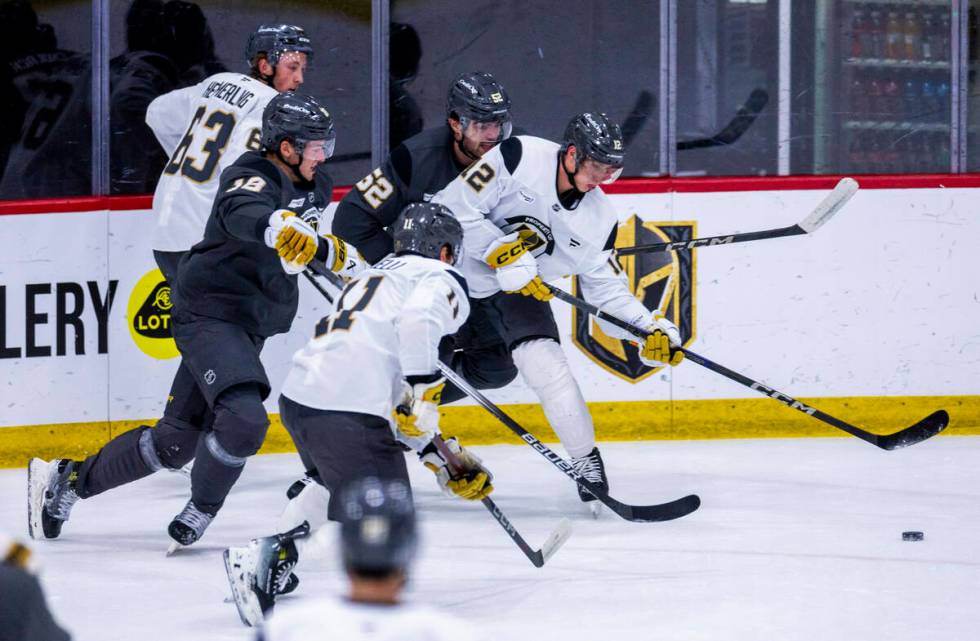 Golden Knights center Jakub Brabenec (12) chases the puck against teammates during the first da ...