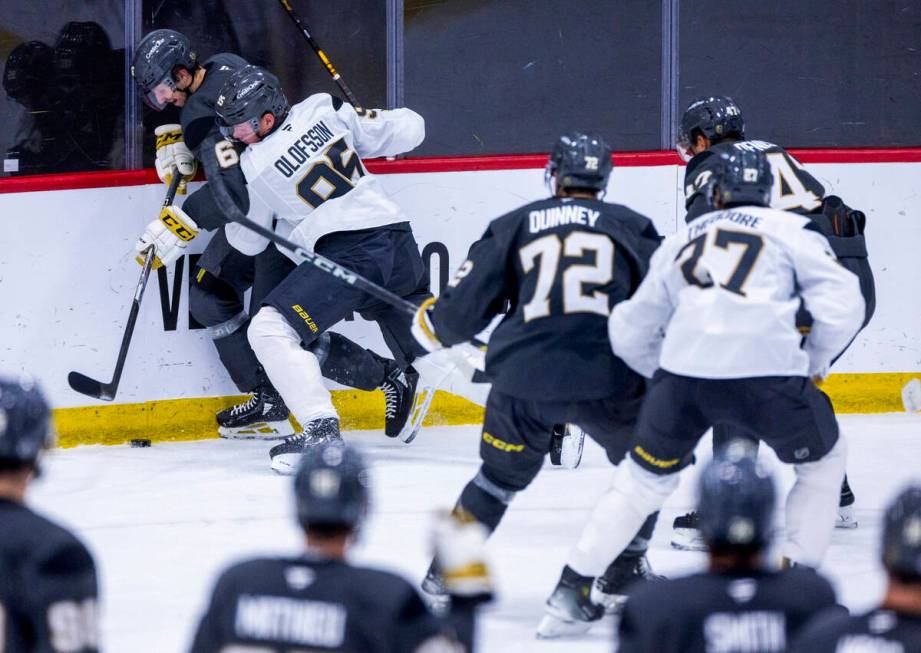 Golden Knights right wing Jonas Rondbjerg (46) is checked into the boards by forward Victor Olo ...