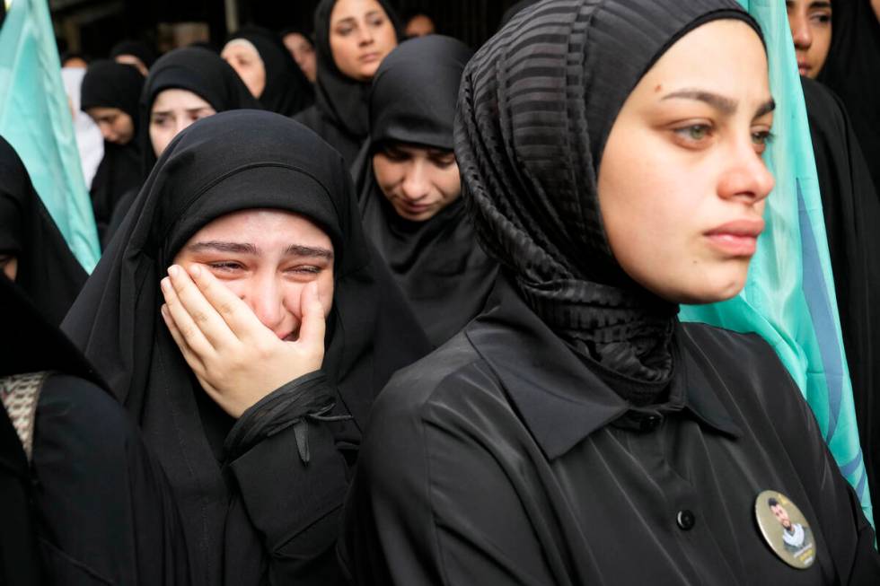 A girl cries during the funeral procession of two Hezbollah members, killed on Wednesday when a ...