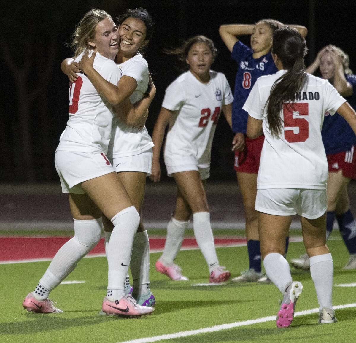 Coronado junior Ryan Neel (10) and freshman Taylor Takahashi (1) hug after a goal is scored dur ...