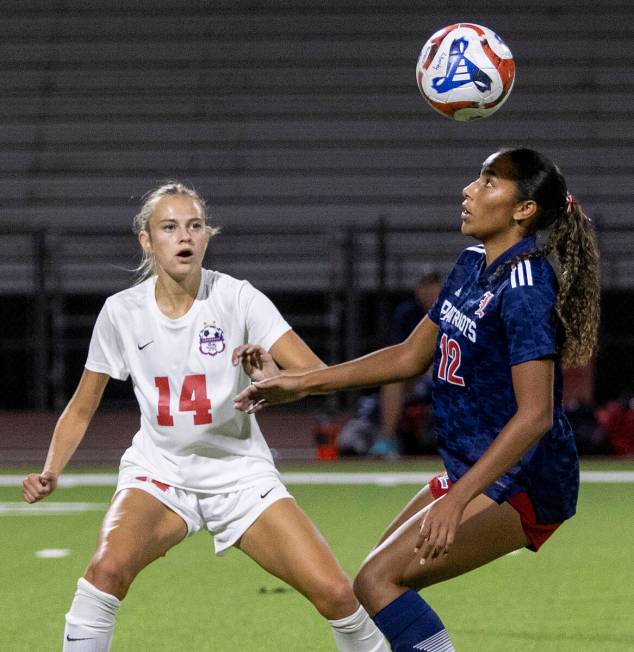 Liberty junior Ayva Jordan (12) and Coronado junior Allison Kleiner (14) compete for the ball d ...