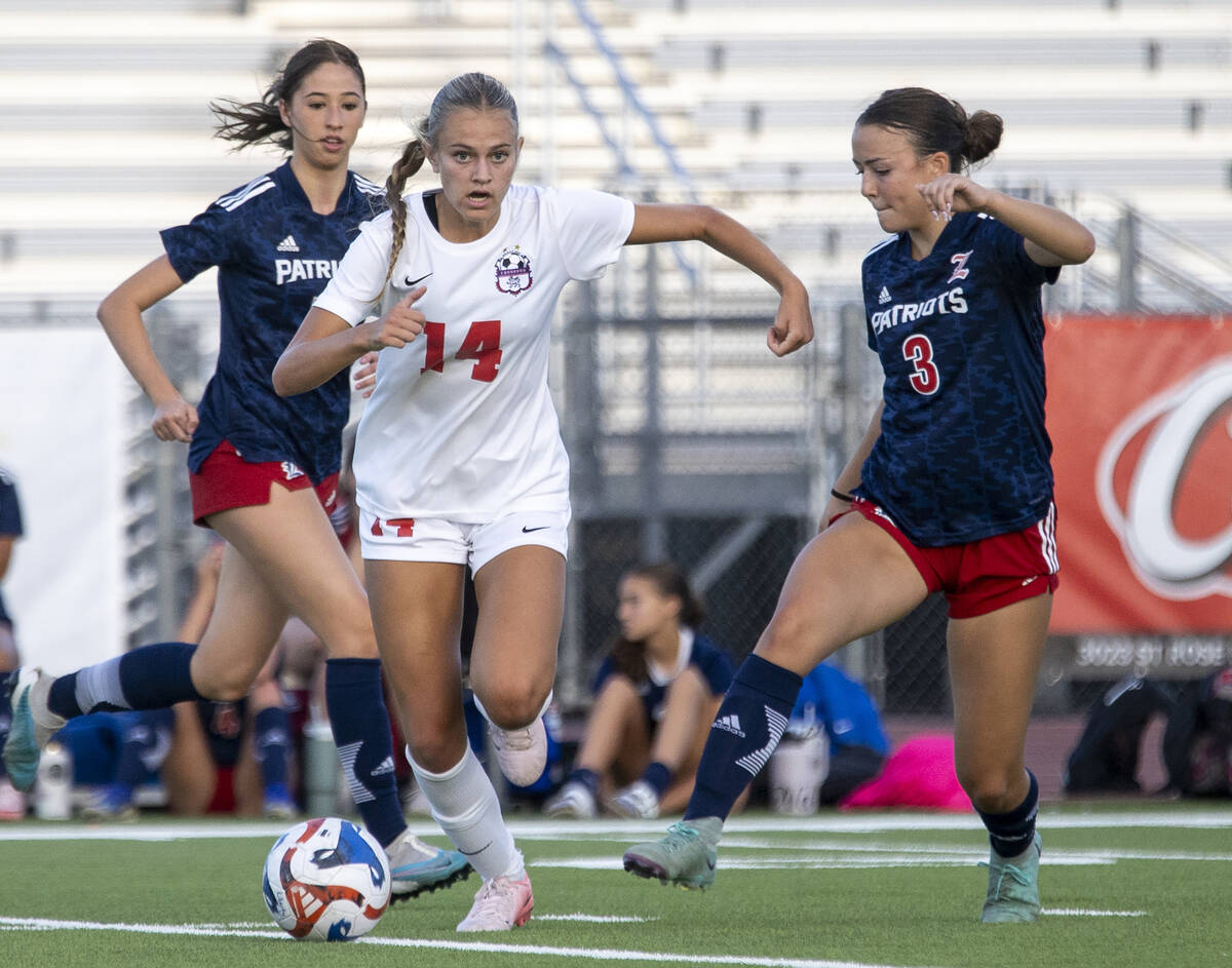 Coronado junior Allison Kleiner (14) avoids Liberty defender Rayen Garrett (3) during the high ...