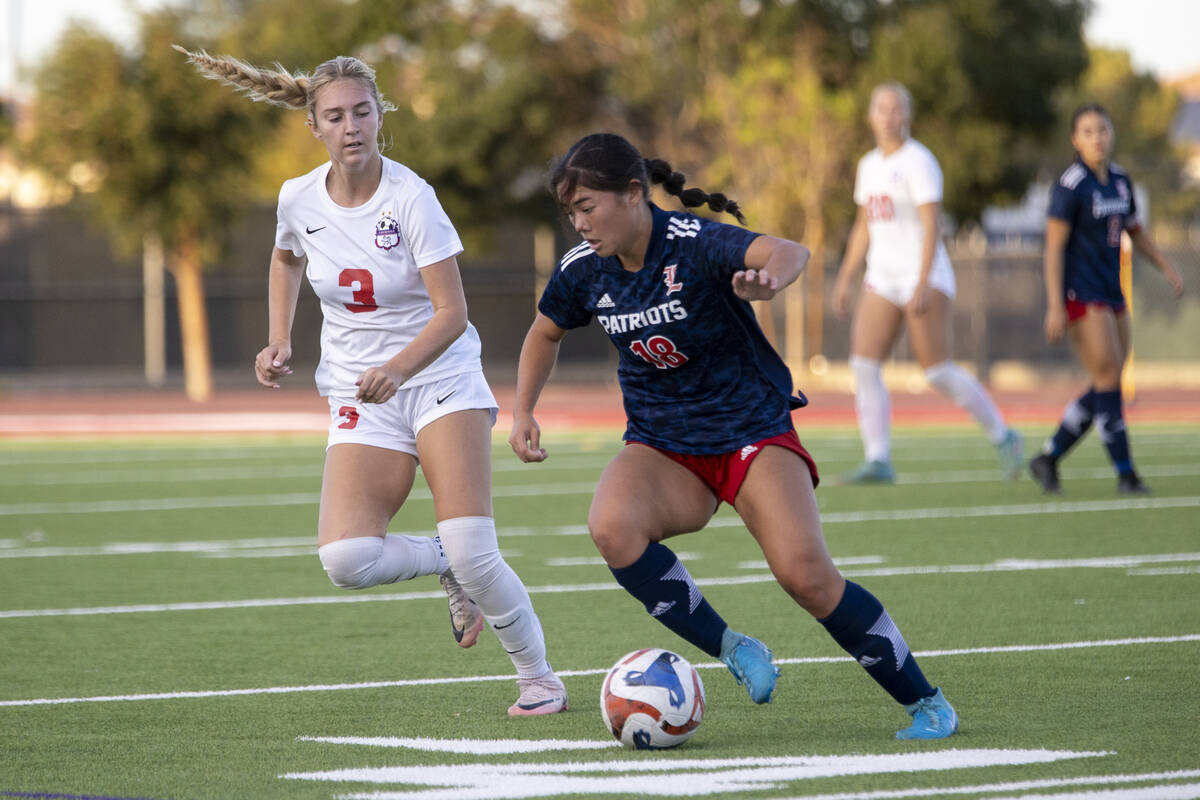 Liberty junior Kaimiinameapono Wills (18) keeps the ball away from Coronado junior Alexandra Mi ...