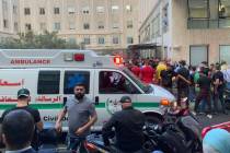 People gather outside the American University hospital after the arrival of several men who wer ...