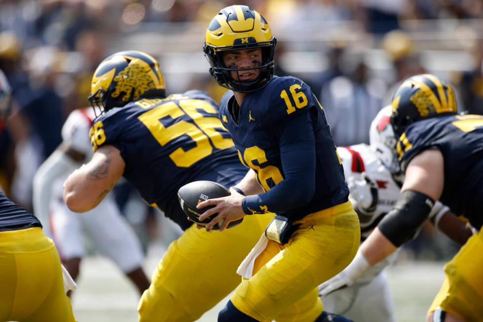 Michigan quarterback Davis Warren (16) plays during an NCAA football game on Saturday, Sept. 14 ...