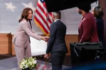 Democratic presidential nominee Vice President Kamala Harris, left, shaking hands with Gerren K ...