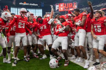 UNLV players celebrate their 72-14 win over Utah Tech with the UNLV Star of Nevada Marching Ban ...