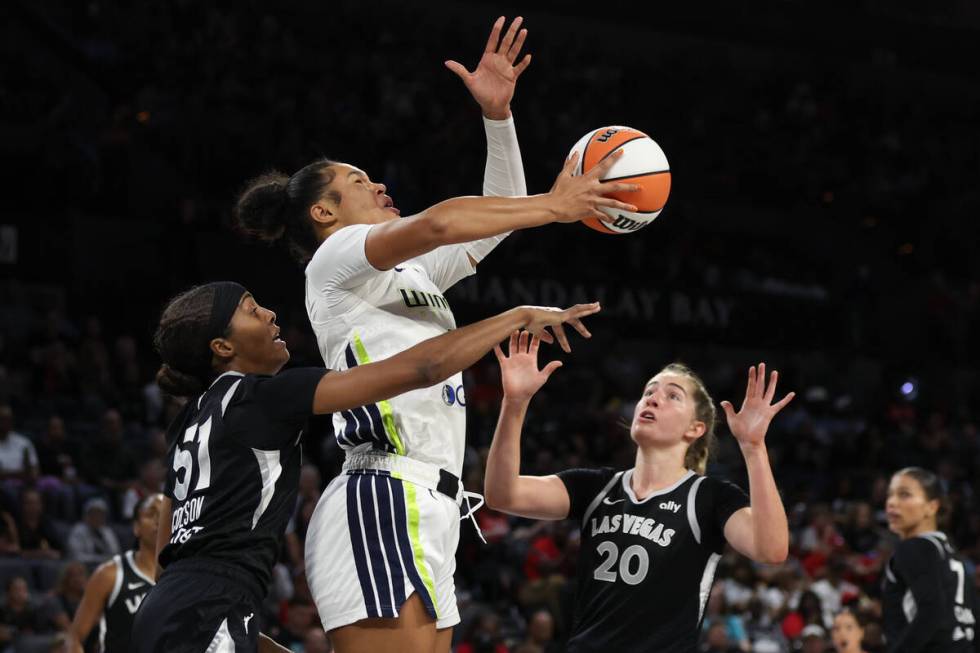 Las Vegas Aces guard Sydney Colson (51) and guard Kate Martin (20) defend against Dallas Wings ...