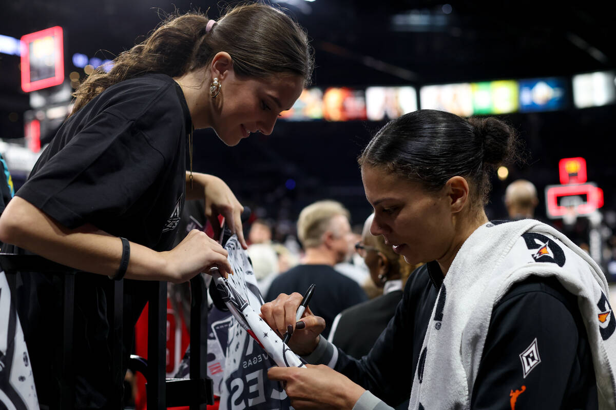 Las Vegas Aces forward Alysha Clark signs an autograph for a fan after winning a WNBA basketbal ...