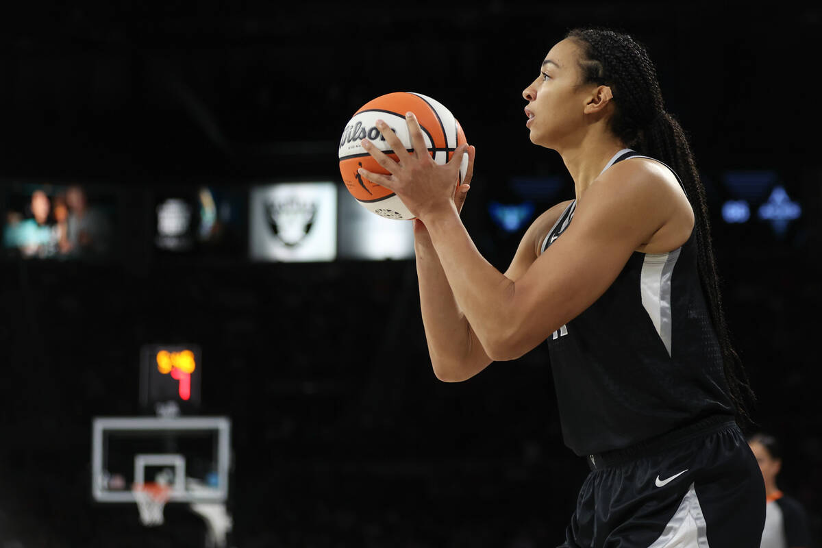 Las Vegas Aces center Kiah Stokes (41) bends to shoot a three-point basket during the second ha ...