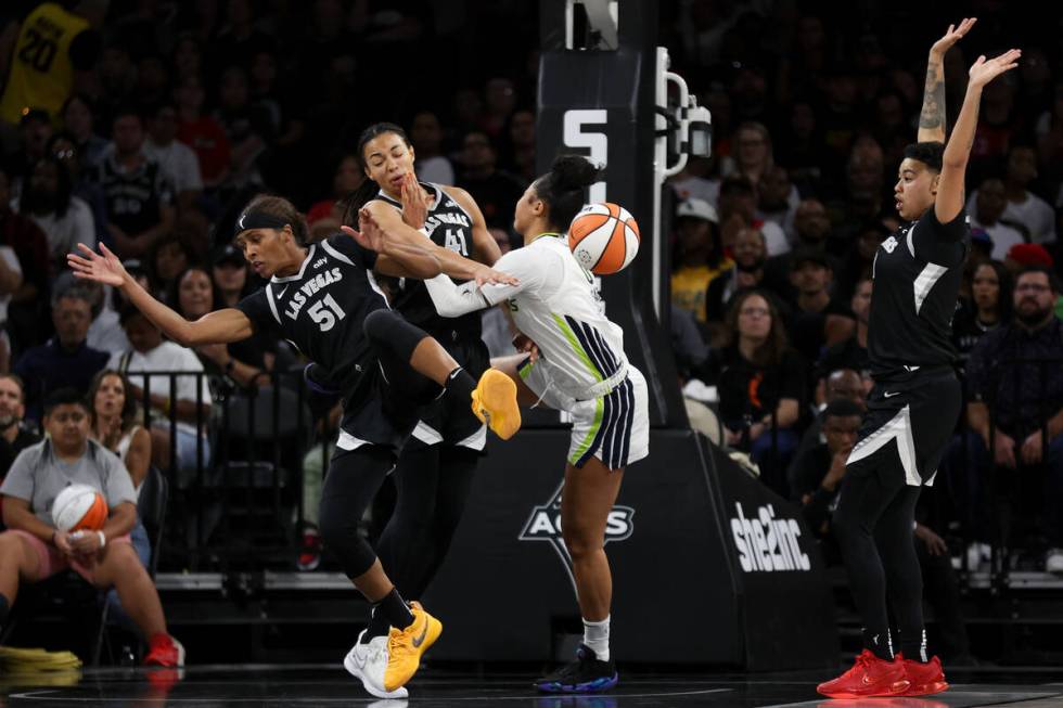 Las Vegas Aces guard Sydney Colson (51) is airborne after attempting to block Dallas Wings forw ...