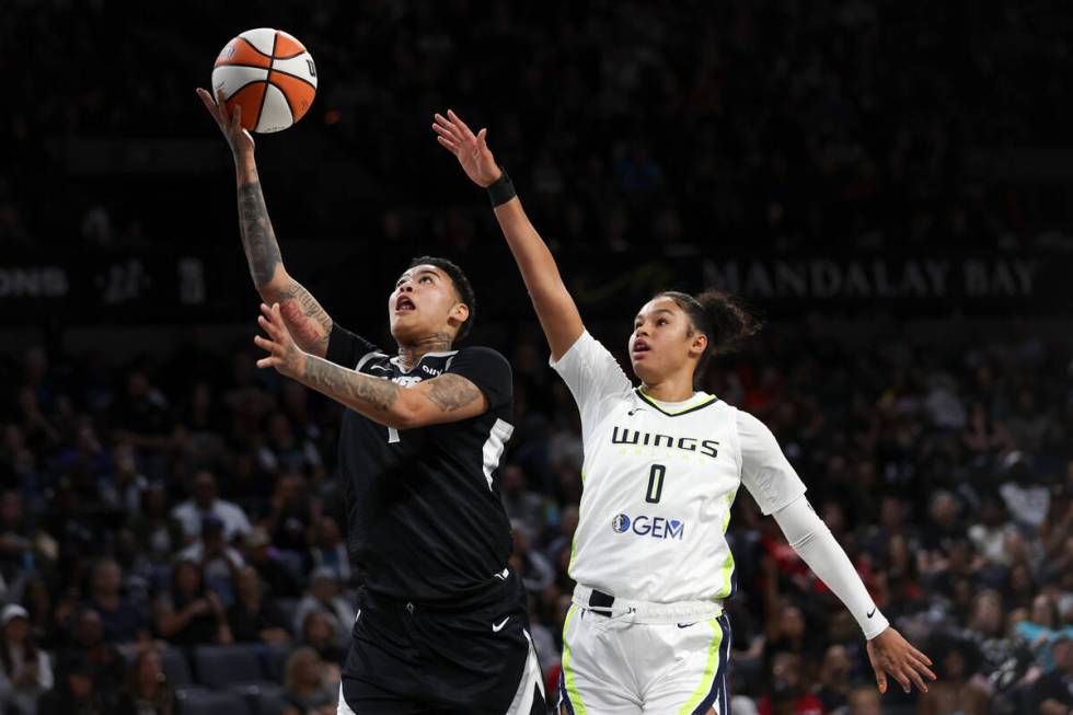 Las Vegas Aces guard Kierstan Bell (1) shoots against Dallas Wings forward Satou Sabally (0) du ...