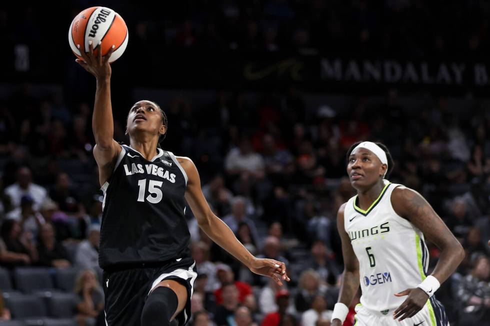 Las Vegas Aces guard Tiffany Hayes (15) shoots against Dallas Wings forward Natasha Howard (6) ...