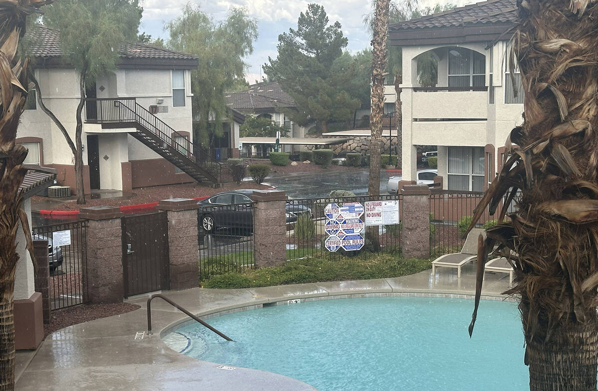 Ripples form in the pool as rain falls at a Henderson apartment complex near Gibson Road and th ...