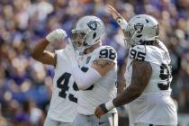 Raiders defensive end Maxx Crosby (98) motions for silence after sacking Baltimore Ravens quart ...