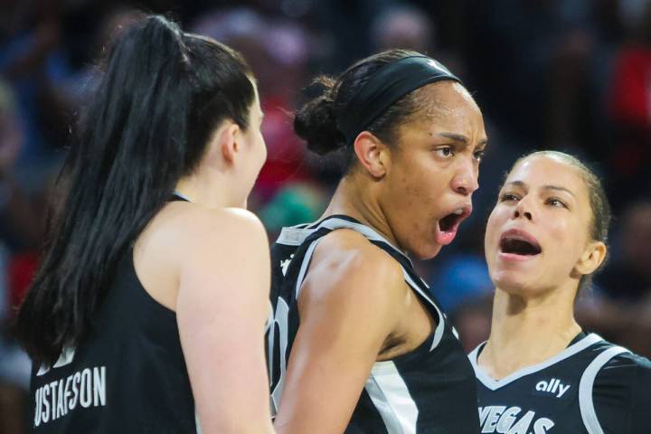 Aces center A'ja Wilson (22) gets pumped up with teammates Alysha Clark (7) and Megan Gustafson ...