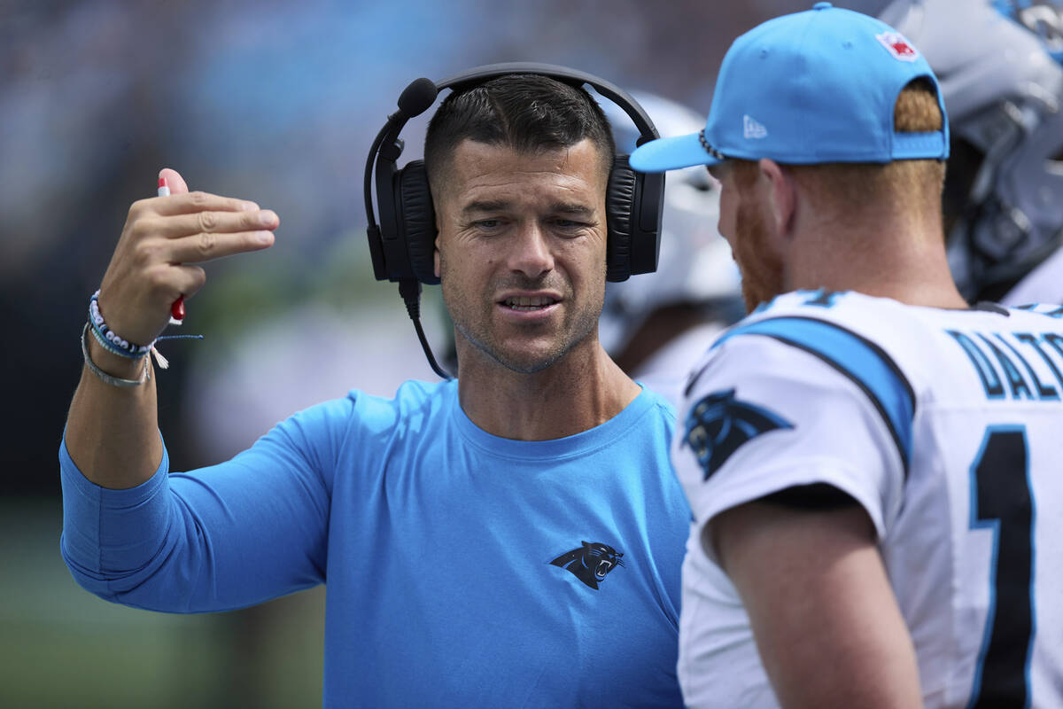 Carolina Panthers head coach Dave Canales talks to backup quarterback Andy Dalton (14) during a ...