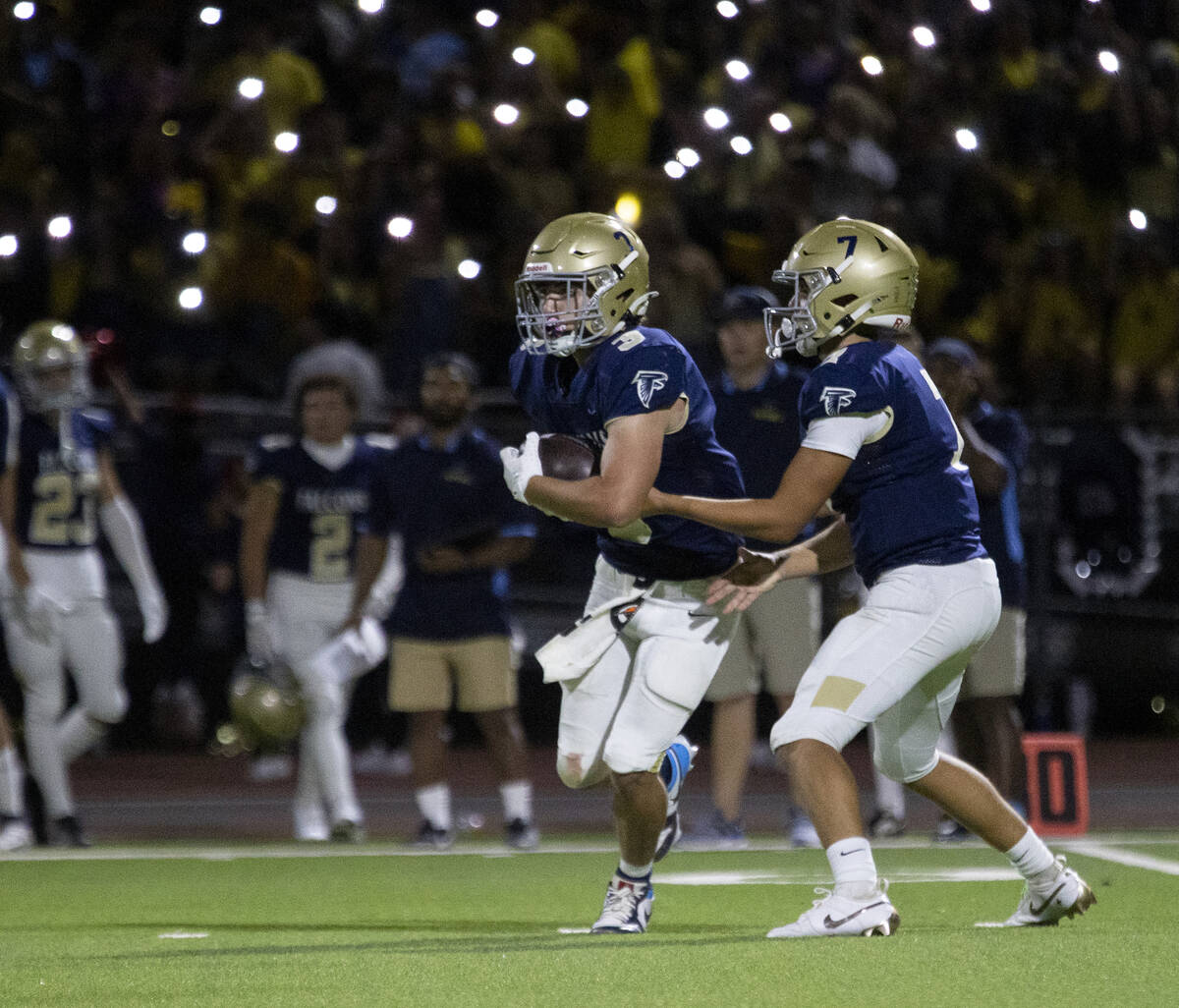 Foothill quarterback Brennon Arthur (7) hands the ball to running back Eugene Altobella III (3) ...