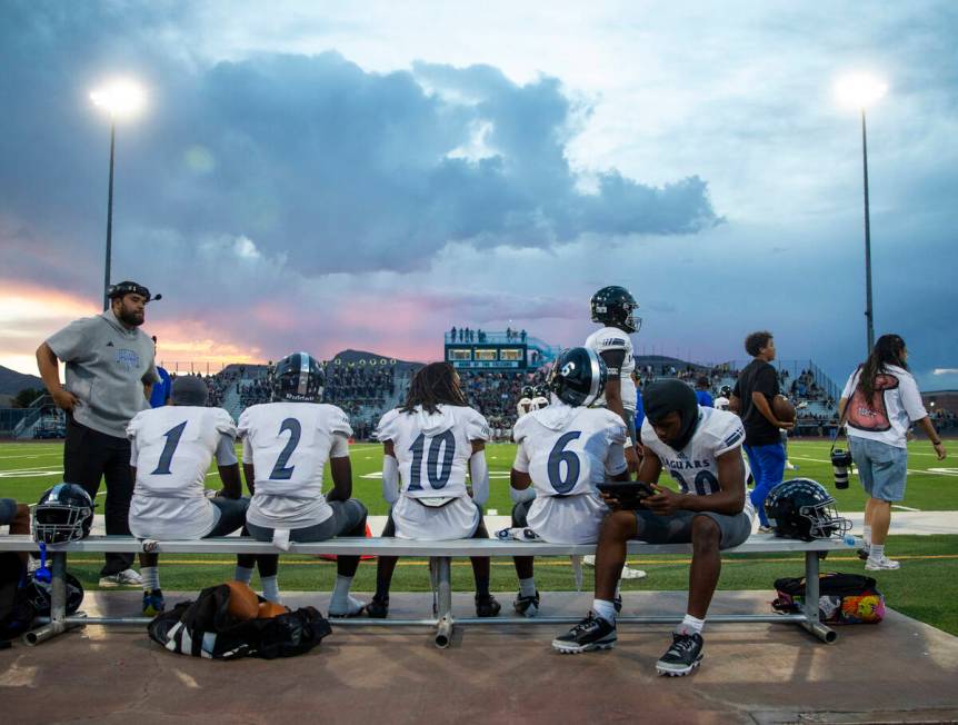 Desert Pines running back Marcus Williams (20) watches film during the high school football gam ...