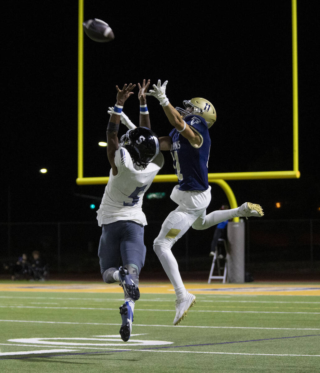 Foothill wide receiver Jaymen Tiss (11) jumps over Desert Pines junior Majik Mcmillion (5) to c ...