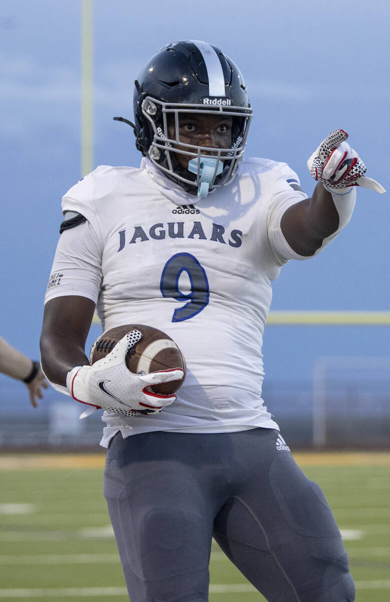 Desert Pines freshman Michael Taylor (9) celebrates making a first down during the high school ...