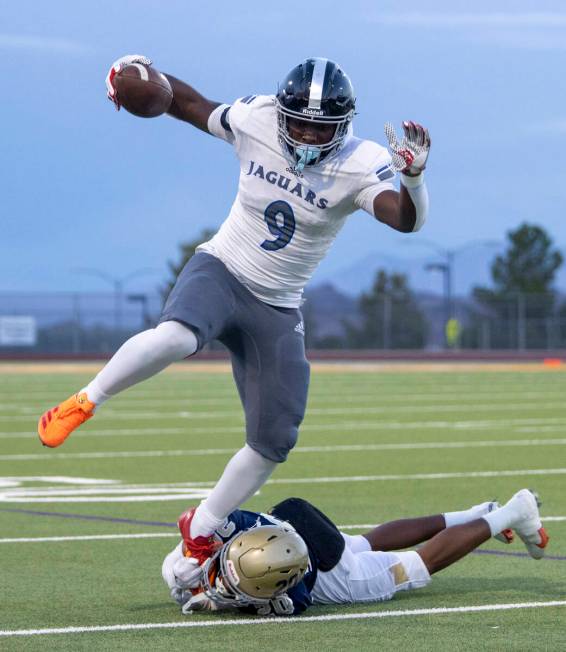 Desert Pines freshman Michael Taylor (9) attempts to hurdle Foothill cornerback Isaiah Sams (20 ...