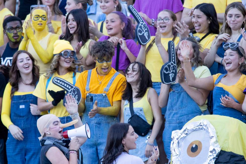 The Foothill student section cheers while dressed as minions during the high school football ga ...