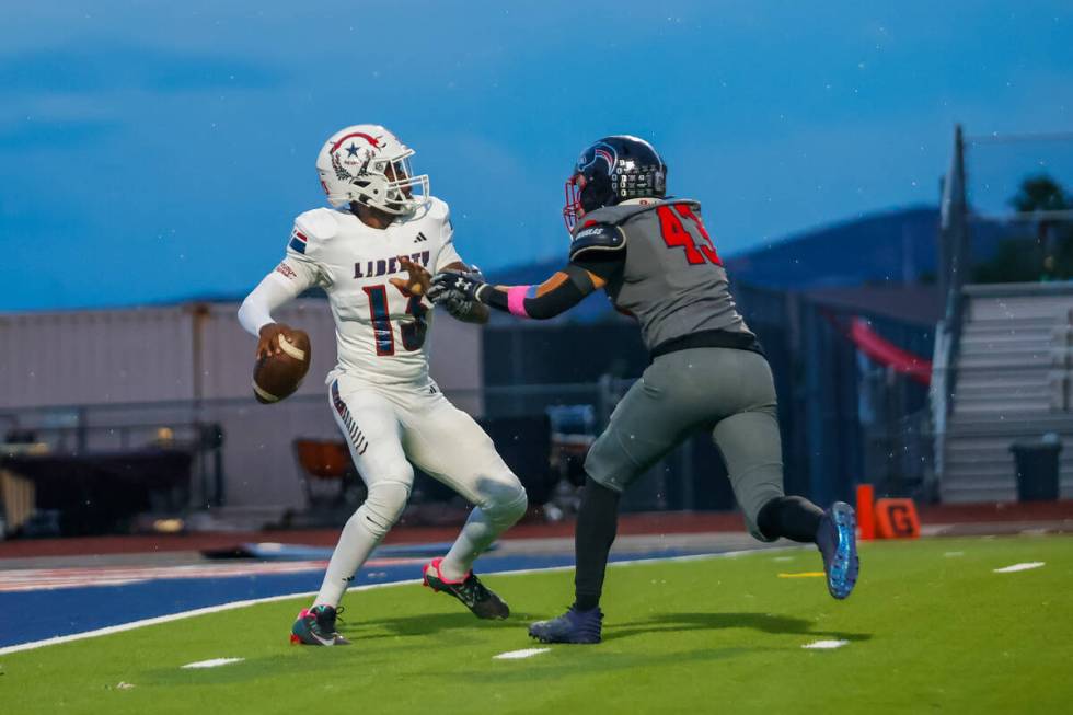 Coronado Linebacker William Bittman (43) looks to tackle Liberty Quarterback Jamar Malone (13) ...