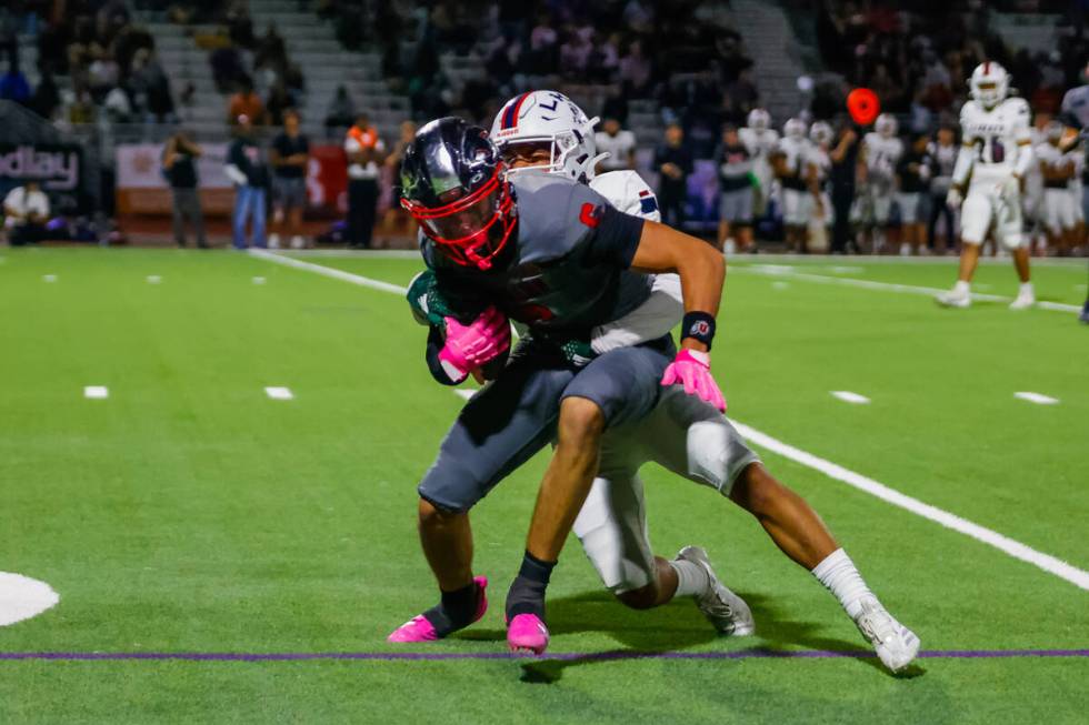 Coronado Wide Receiver JJ Buchanan (6) tries to break a tackle after making a reception during ...