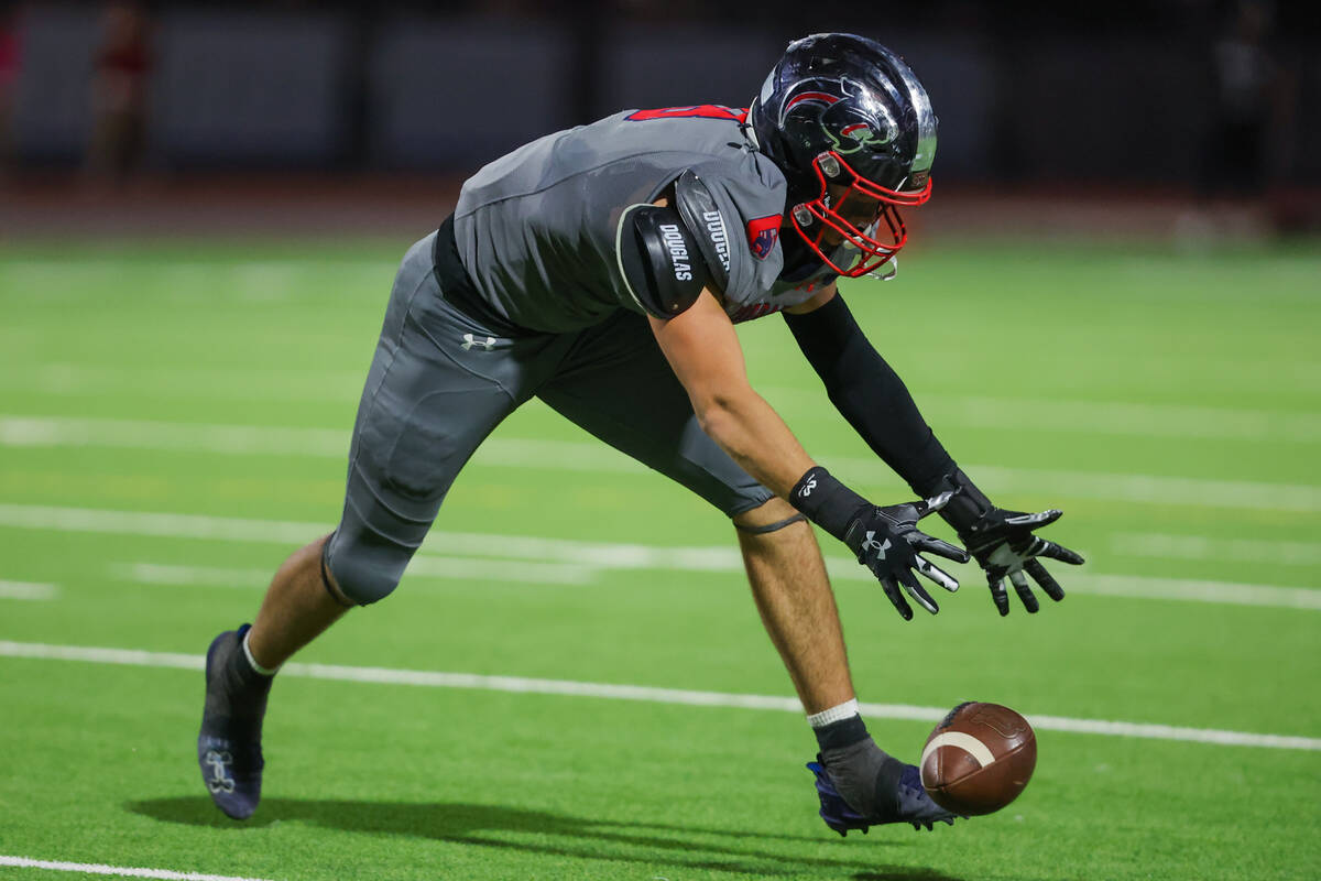 Coronado defensive end/tight end Neville Roberts misses the ball during a football game between ...