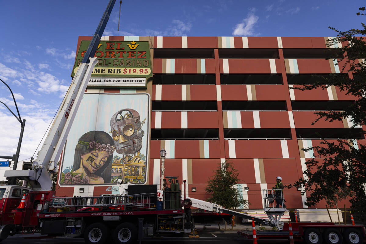 YESCO employees prepare to remove an El Cortez sign dating back to 1974 from the parking garage ...