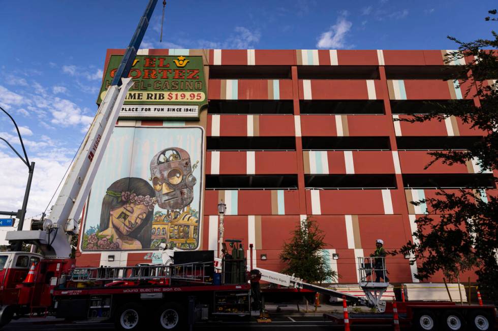 YESCO employees prepare to remove an El Cortez sign dating back to 1974 from the parking garage ...