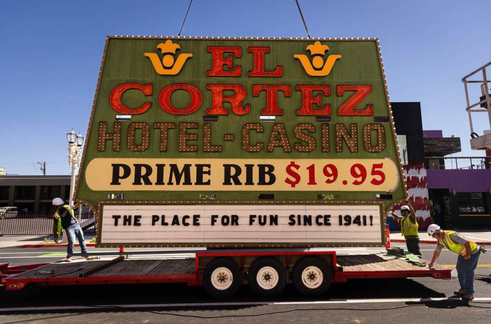 YESCO employees guide an El Cortez neon sign, originally installed in 1974, after it was remove ...