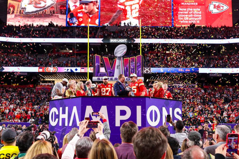 Kansas City Chiefs quarterback Patrick Mahomes (15) holds the Vince Lombardi Trophy after winni ...